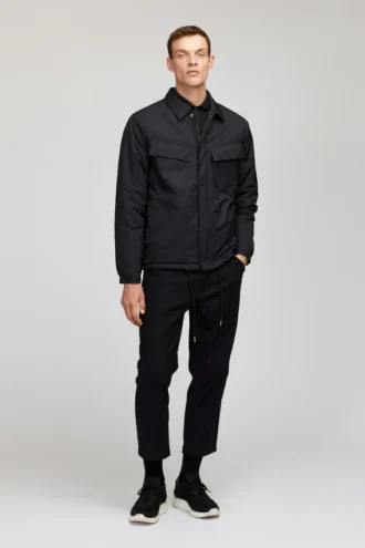 Den quiltade Coachs-jackan